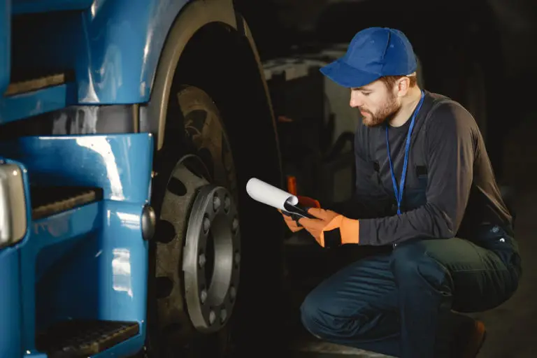 young-worker-checks-wheel-truck-malfunction-servic